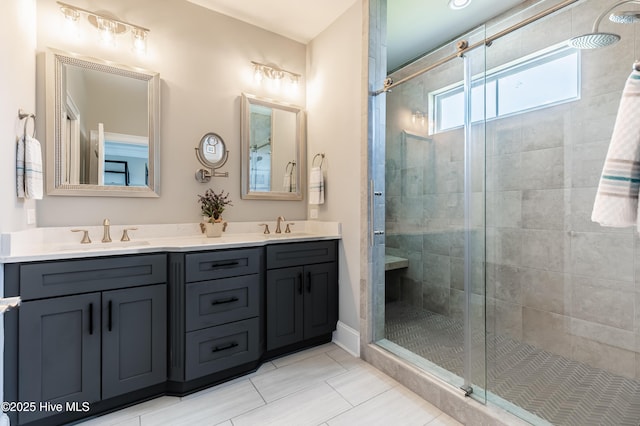 full bath featuring a shower stall, double vanity, and tile patterned floors