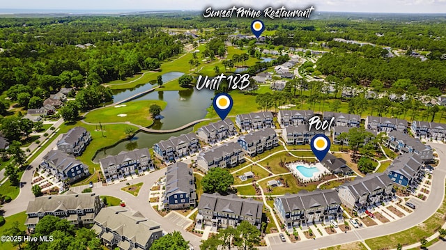 aerial view of residential area featuring a large body of water and a golf course