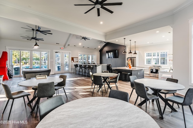 dining room with light wood-style flooring, ornamental molding, recessed lighting, and french doors
