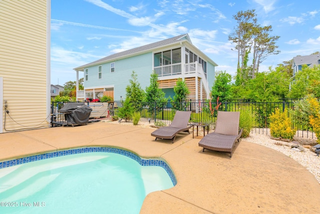 104 SE 32nd St, Oak Island, NC 28465 - view of swimming pool with a patio area, fence, and a sunroom