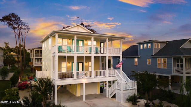 104 SE 32nd St, Oak Island, NC 28465 - rear view of property with a carport, stairs, concrete driveway, and a balcony