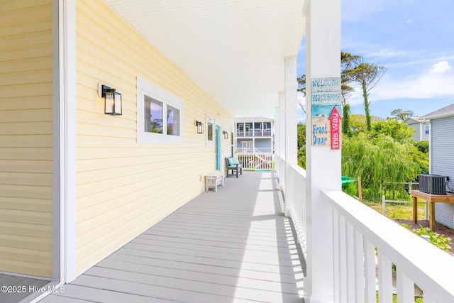 104 SE 32nd St, Oak Island, NC 28465 - deck featuring covered porch and central AC unit