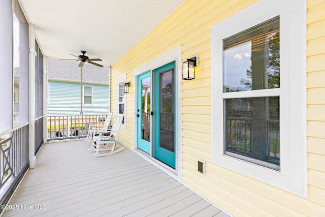 104 SE 32nd St, Oak Island, NC 28465 - wooden terrace with covered porch and a ceiling fan
