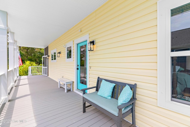 104 SE 32nd St, Oak Island, NC 28465 - wooden terrace featuring covered porch