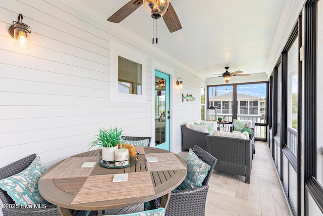 104 SE 32nd St, Oak Island, NC 28465 - sunroom featuring a ceiling fan, outdoor dining area, and an outdoor living space