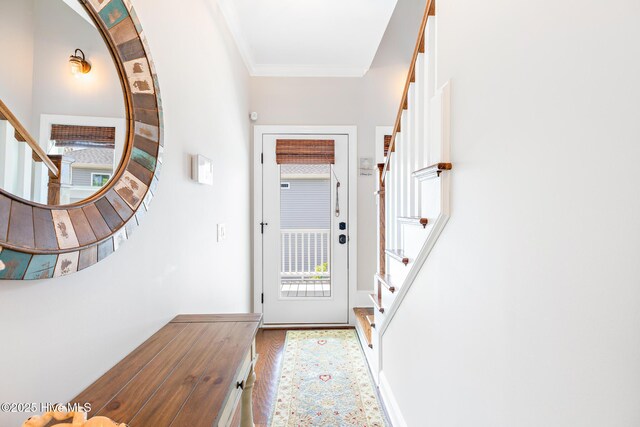 104 SE 32nd St, Oak Island, NC 28465 - entryway featuring stairs, wood finished floors, and crown molding