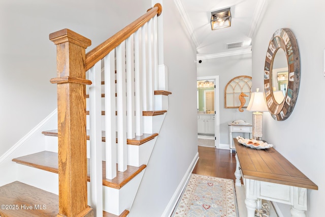104 SE 32nd St, Oak Island, NC 28465 - stairway with ornamental molding, wood finished floors, and baseboards