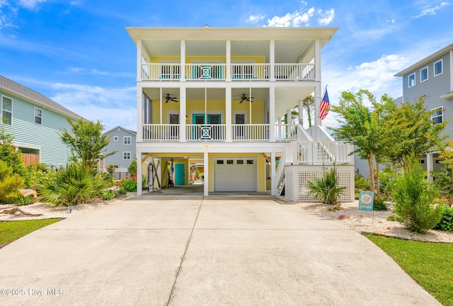 104 SE 32nd St, Oak Island, NC 28465 - coastal inspired home featuring ceiling fan, driveway, a carport, a balcony, and stairway