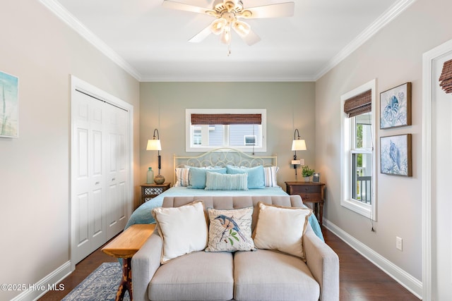 104 SE 32nd St, Oak Island, NC 28465 - bedroom with dark wood-style floors, a closet, ornamental molding, baseboards, and ceiling fan