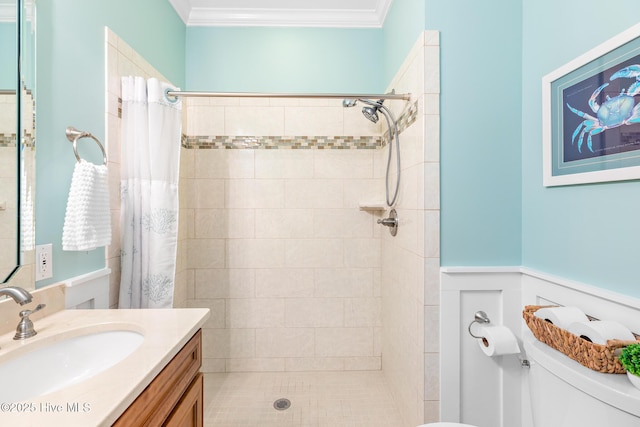 104 SE 32nd St, Oak Island, NC 28465 - bathroom featuring toilet, a tile shower, crown molding, a wainscoted wall, and vanity