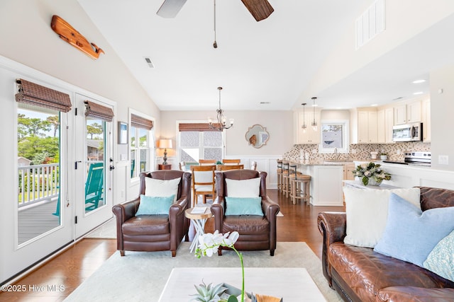 104 SE 32nd St, Oak Island, NC 28465 - living room featuring lofted ceiling, light wood-type flooring, a chandelier, and a ceiling fan