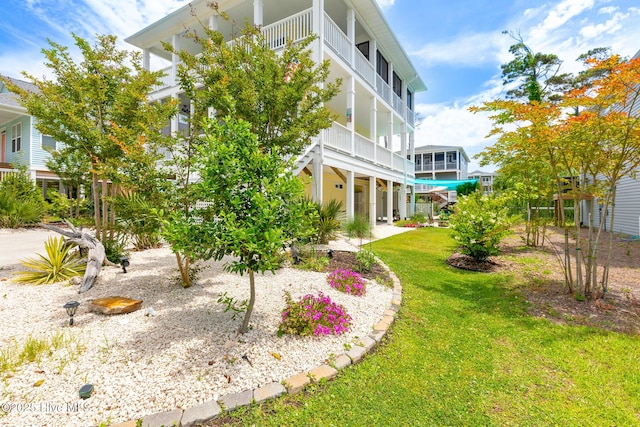 104 SE 32nd St, Oak Island, NC 28465 - view of grassy yard with a balcony