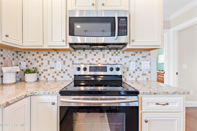 104 SE 32nd St, Oak Island, NC 28465 - kitchen featuring appliances with stainless steel finishes, crown molding, white cabinets, backsplash, and light stone countertops