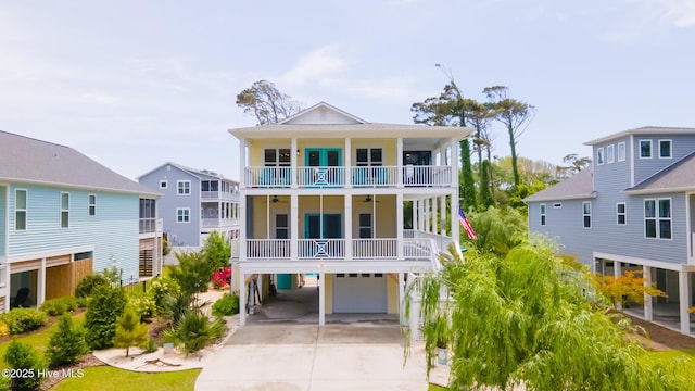 104 SE 32nd St, Oak Island, NC 28465 - coastal inspired home with an attached garage, a balcony, concrete driveway, and a carport