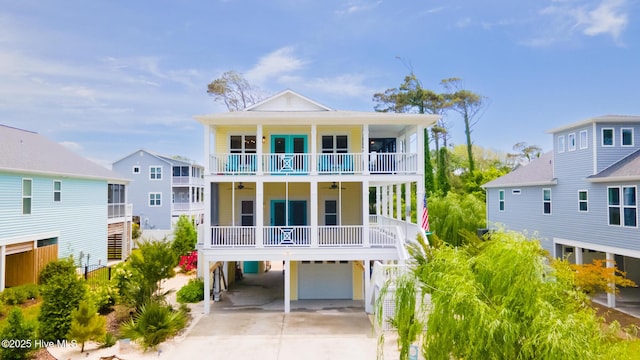 104 SE 32nd St, Oak Island, NC 28465 - coastal home with a garage, driveway, a ceiling fan, a balcony, and a carport