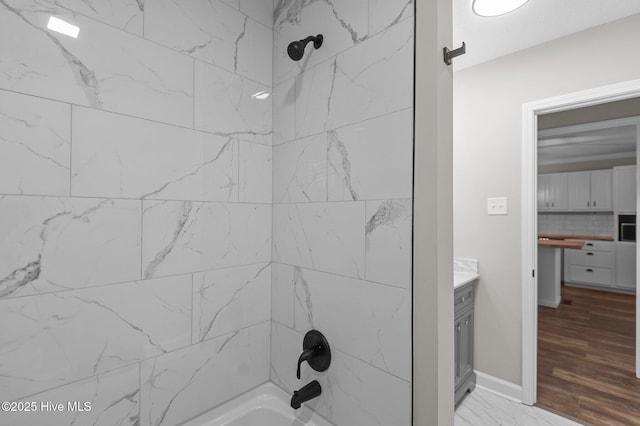 bathroom featuring shower / bath combination and vanity