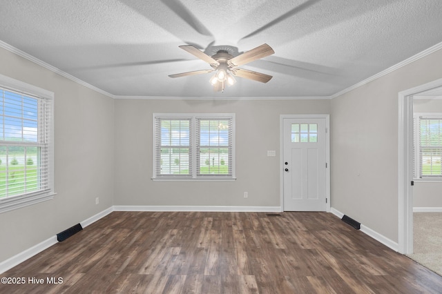 foyer entrance featuring plenty of natural light, dark wood-style flooring, ceiling fan, a textured ceiling, and baseboards