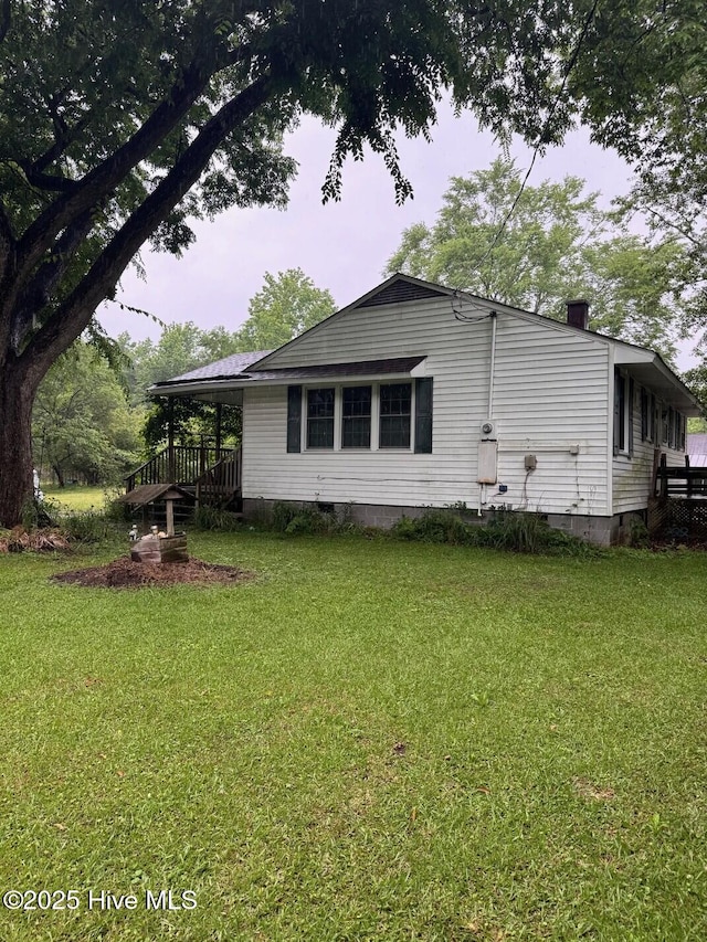 6748 Pitt St, Grifton, NC 28530 - view of side of home featuring a lawn, crawl space, and a chimney