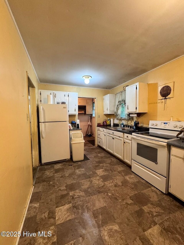 6748 Pitt St, Grifton, NC 28530 - kitchen with white appliances, dark countertops, a sink, and white cabinets