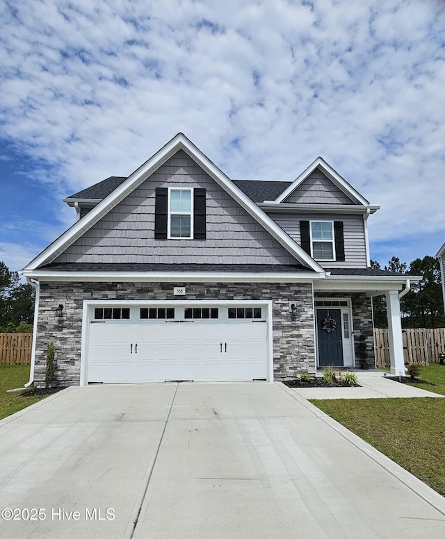 568 Transom Way, Sneads Ferry, NC 28460 - craftsman-style home featuring fence, concrete driveway, and stone siding