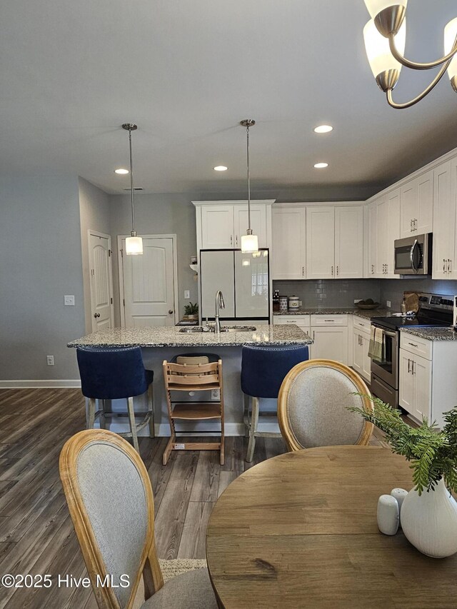 568 Transom Way, Sneads Ferry, NC 28460 - kitchen featuring stainless steel appliances, a center island with sink, white cabinetry, dark wood-type flooring, and recessed lighting