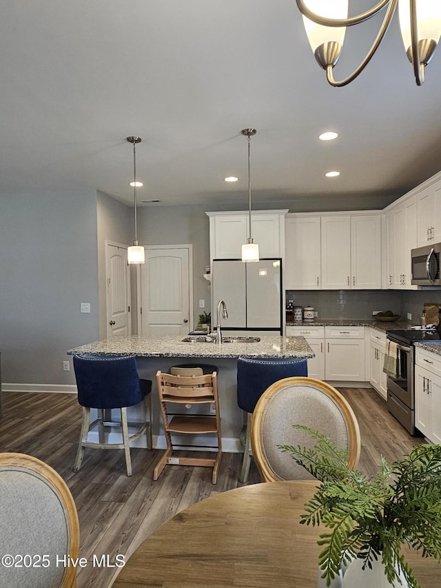 568 Transom Way, Sneads Ferry, NC 28460 - kitchen with appliances with stainless steel finishes, a sink, dark wood-style floors, white cabinets, and recessed lighting