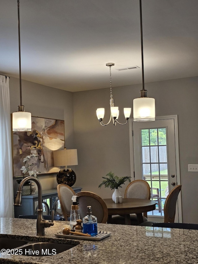 568 Transom Way, Sneads Ferry, NC 28460 - kitchen featuring a sink, stone countertops, a chandelier, and hanging light fixtures