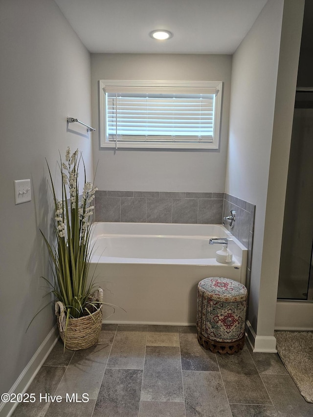 568 Transom Way, Sneads Ferry, NC 28460 - bathroom featuring plenty of natural light, a bath, and baseboards