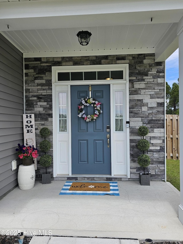 568 Transom Way, Sneads Ferry, NC 28460 - view of exterior entry featuring stone siding and fence