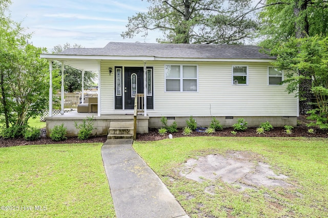 view of front of property featuring crawl space, a front lawn, covered porch, and roof with shingles