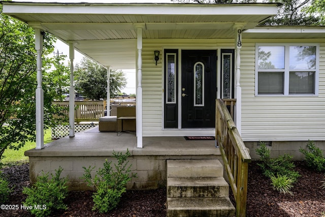 doorway to property with a porch and crawl space