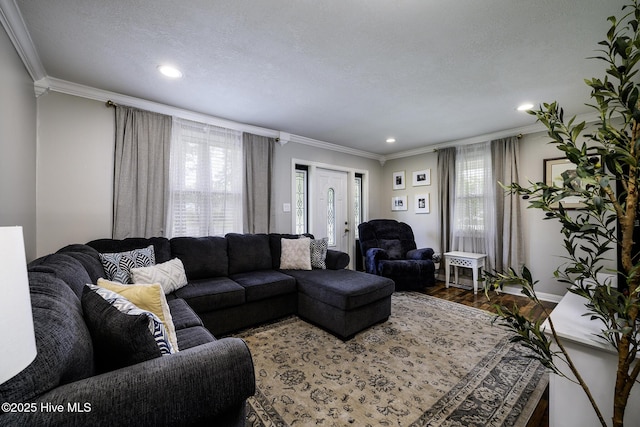 living room featuring crown molding, plenty of natural light, recessed lighting, wood finished floors, and baseboards