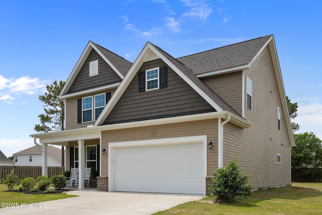 craftsman-style house with covered porch, driveway, roof with shingles, and fence