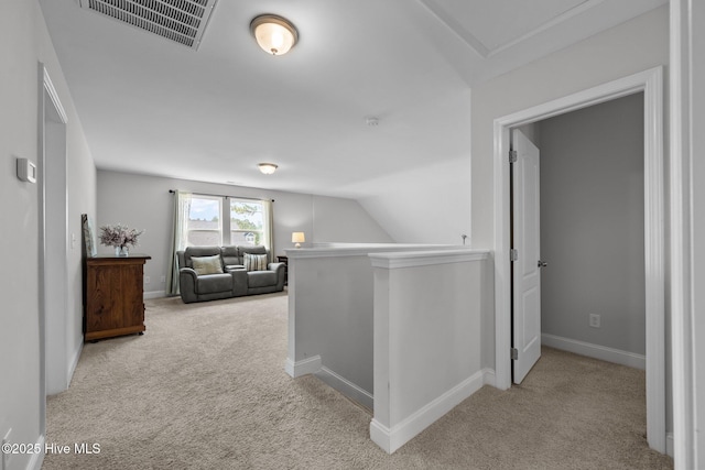 hallway featuring carpet flooring, an upstairs landing, baseboards, and lofted ceiling