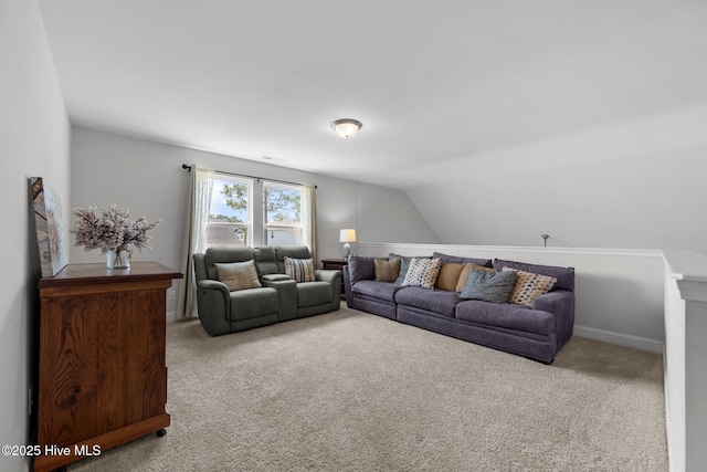 carpeted living area with lofted ceiling
