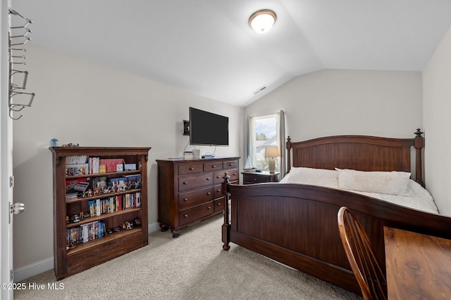 bedroom featuring vaulted ceiling, light colored carpet, and baseboards