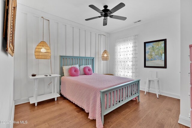 2304 W Dolphin Dr, Oak Island, NC 28465 - bedroom featuring wood finished floors, baseboards, and a ceiling fan