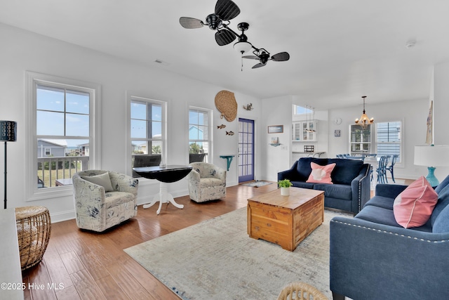 2304 W Dolphin Dr, Oak Island, NC 28465 - living room with a chandelier, wood finished floors, and baseboards