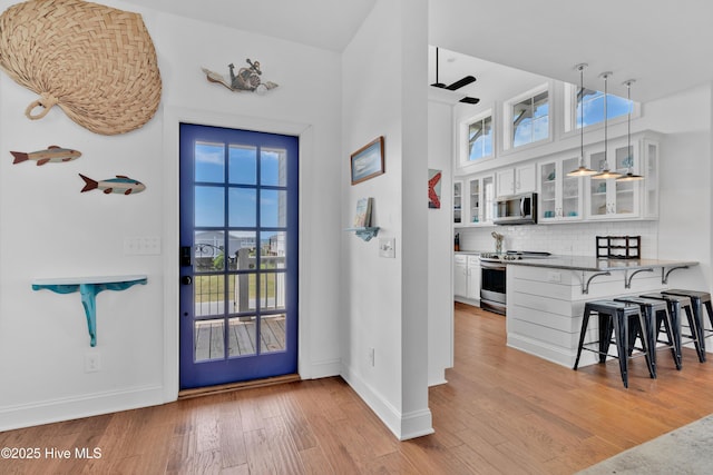 2304 W Dolphin Dr, Oak Island, NC 28465 - entrance foyer with wood finished floors, baseboards, and ceiling fan