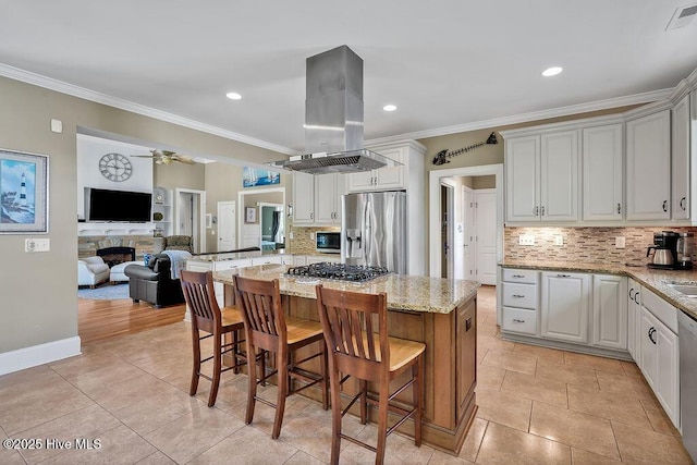 886 Hollybriar Dr SE, Bolivia, NC 28422 - kitchen with stainless steel appliances, island exhaust hood, decorative backsplash, a breakfast bar area, and crown molding