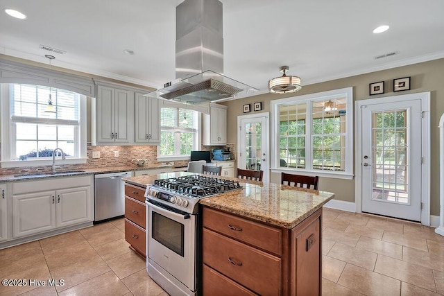 886 Hollybriar Dr SE, Bolivia, NC 28422 - kitchen with stainless steel appliances, a sink, island range hood, light tile patterned floors, and light stone counters