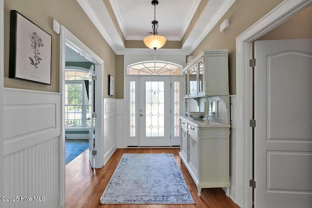 886 Hollybriar Dr SE, Bolivia, NC 28422 - foyer entrance featuring a tray ceiling, dark wood-style flooring, ornamental molding, and a wainscoted wall