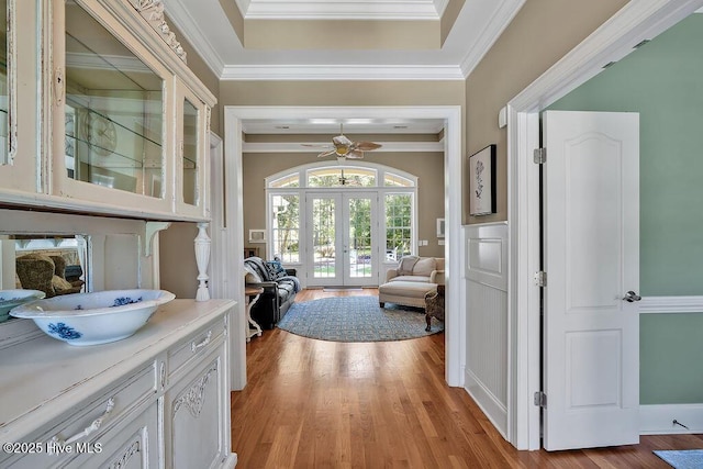 886 Hollybriar Dr SE, Bolivia, NC 28422 - corridor featuring french doors, light wood-style flooring, crown molding, and a tray ceiling