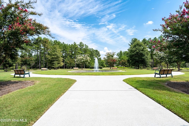 886 Hollybriar Dr SE, Bolivia, NC 28422 - view of community featuring a lawn and view of wooded area