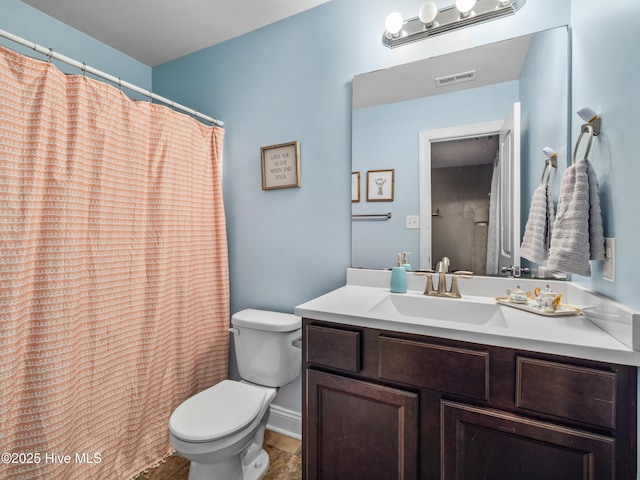 bathroom featuring toilet and vanity