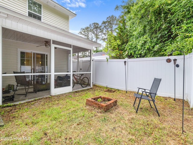 view of yard with a sunroom and ceiling fan