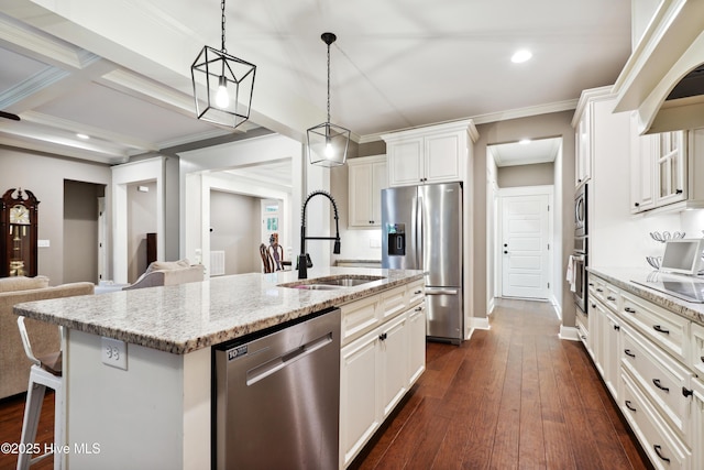 kitchen with appliances with stainless steel finishes, a sink, a center island with sink, light stone countertops, and dark wood-type flooring