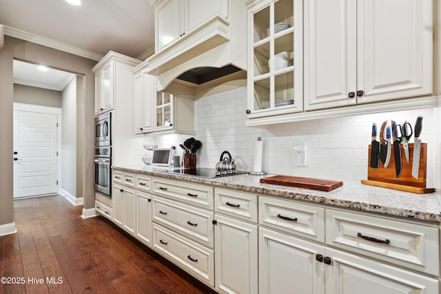 kitchen with stainless steel appliances, baseboards, tasteful backsplash, crown molding, and light stone countertops