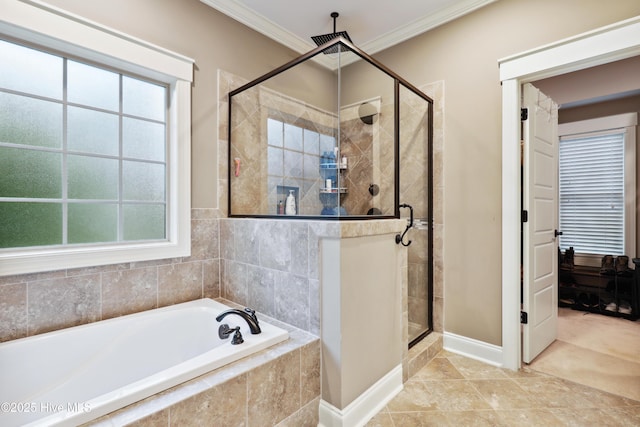 bathroom with a stall shower, a bath, healthy amount of natural light, crown molding, and baseboards
