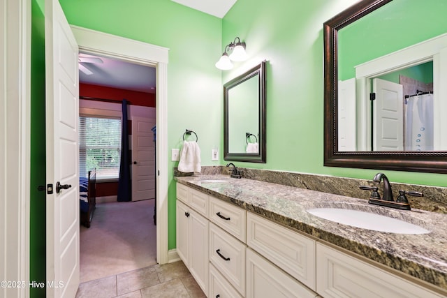 ensuite bathroom with double vanity and tile patterned flooring